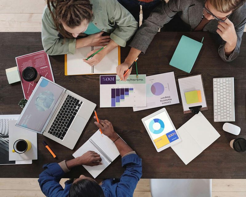 grupo de trabajo, personas en una mesa trabajando con estadística